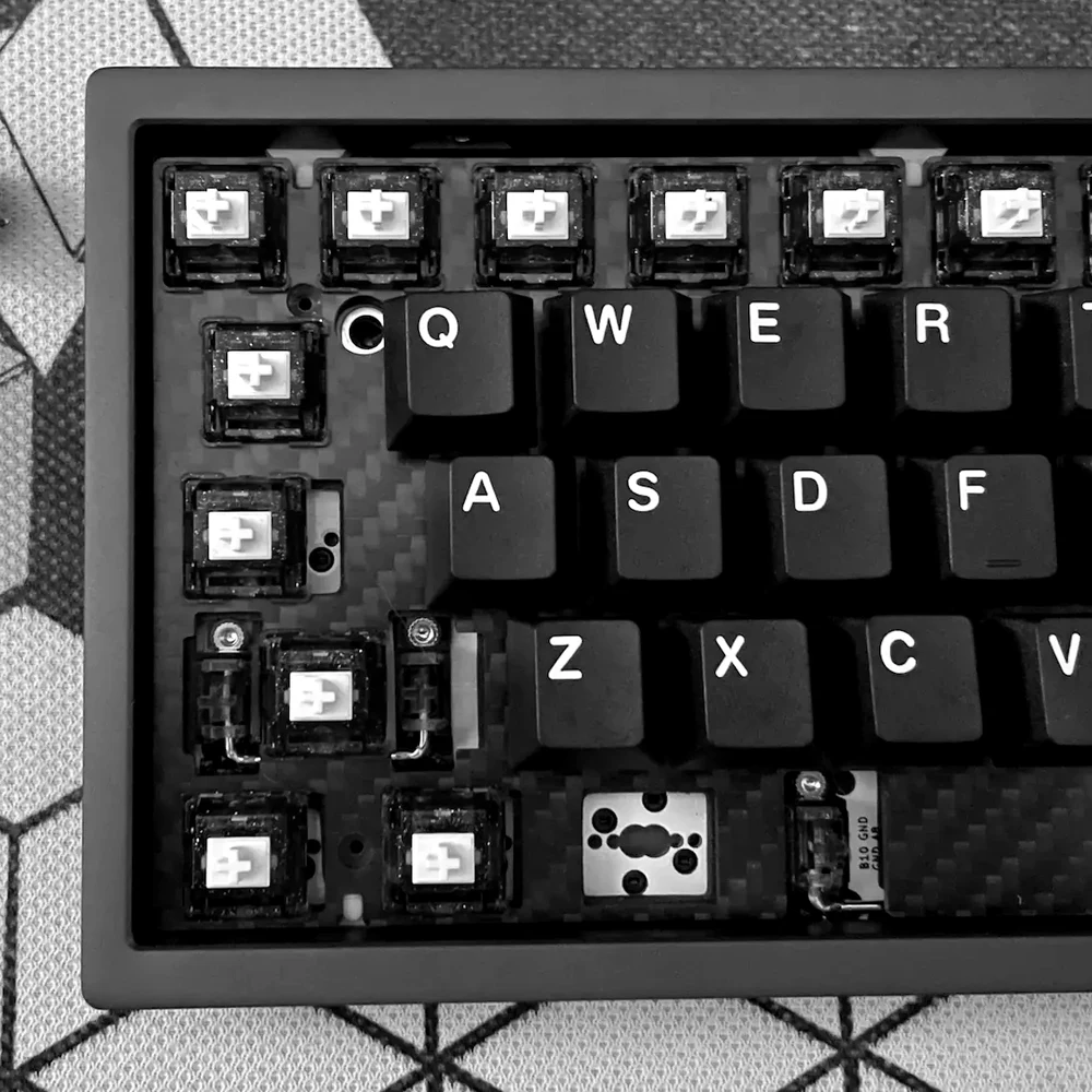 A mechanical keyboard mid-build with switches removed